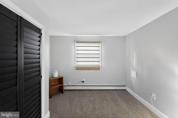 a view of a room with gym equipment and a window