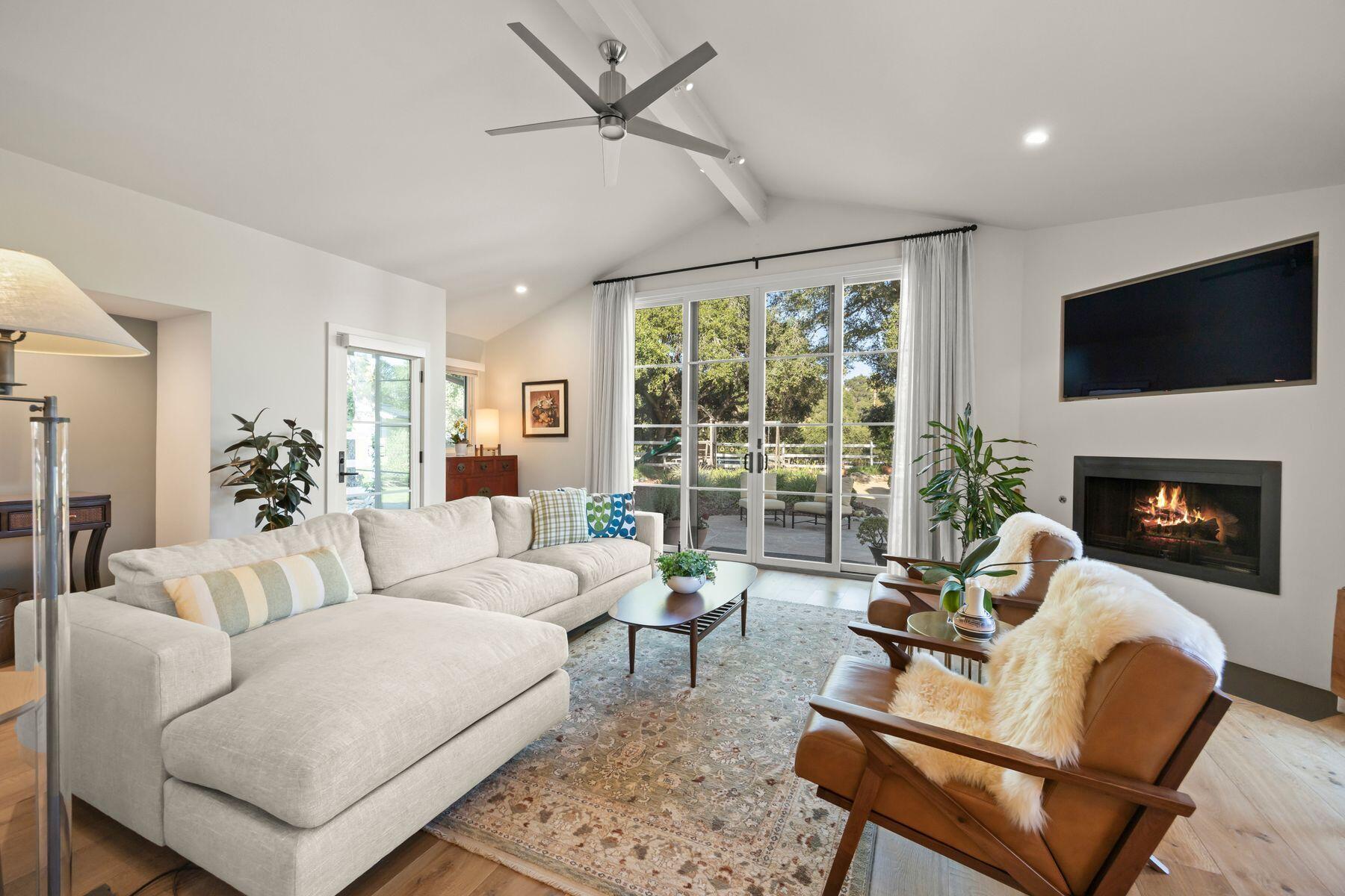 10929 Encino Drive Oak View, CA 93022 - Photo 14 of 50 a living room with furniture a fireplace and a flat screen tv