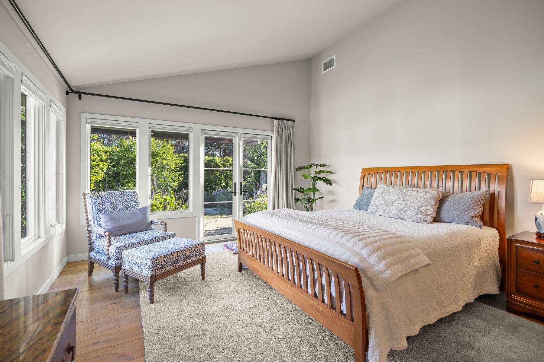 10929 Encino Drive Oak View, CA 93022 - Photo 17 of 50 a bedroom with a bed and glass window