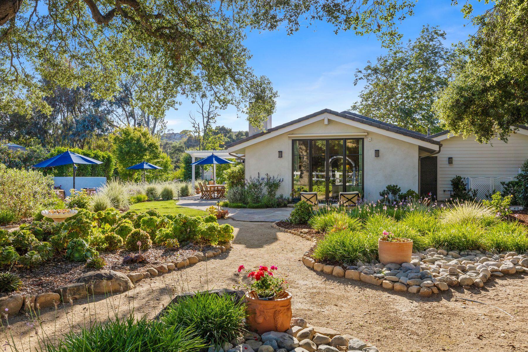 10929 Encino Drive Oak View, CA 93022 - Photo 2 of 50 a front view of a house with a yard and potted plants
