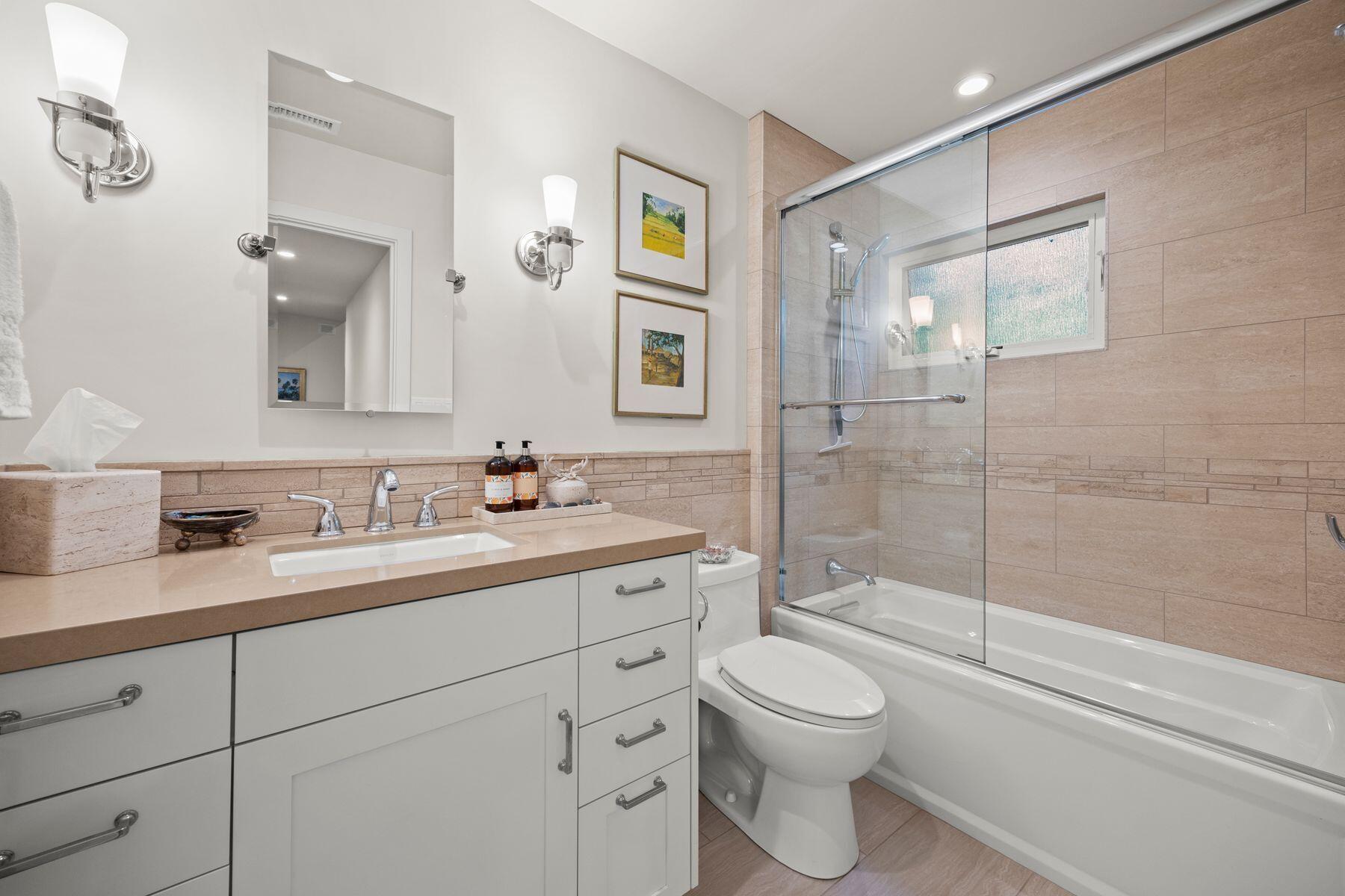 10929 Encino Drive Oak View, CA 93022 - Photo 24 of 50 a bathroom with a granite countertop toilet sink and shower