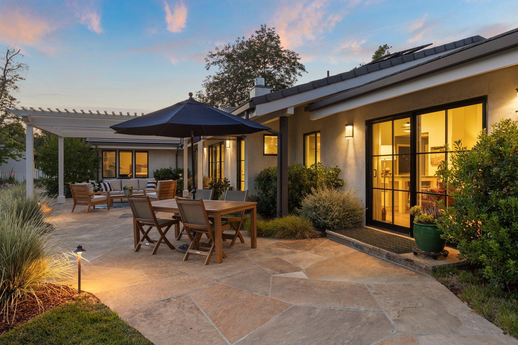 10929 Encino Drive Oak View, CA 93022 - Photo 28 of 50 a view of a patio with table and chairs potted plants and floor to ceiling window
