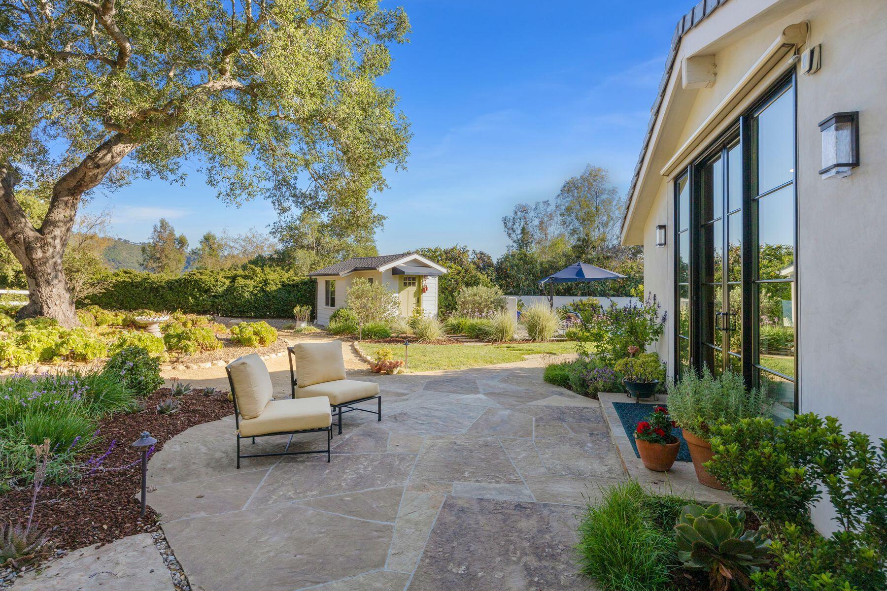 10929 Encino Drive Oak View, CA 93022 - Photo 44 of 50 a view of a patio with couches and table and chairs and potted plants