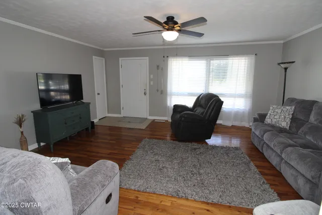 a living room with furniture and a flat screen tv