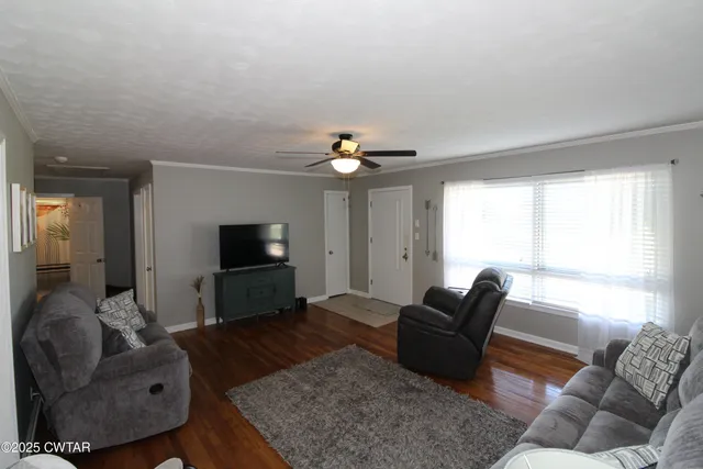 a living room with furniture and a flat screen tv