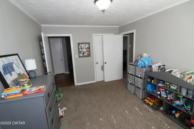 a view of a livingroom with wooden floor and chandelier