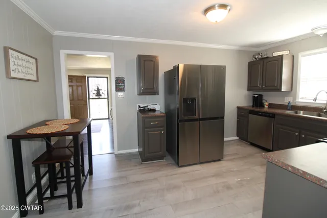 a kitchen with a refrigerator and a sink