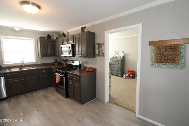 a kitchen with stainless steel appliances granite countertop a refrigerator and a sink