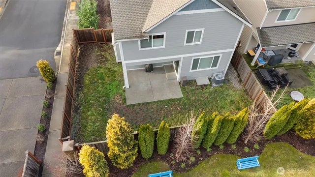 aerial view of a house with a yard and potted plants