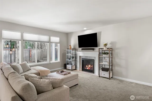 a living room with furniture a fireplace and a flat screen tv