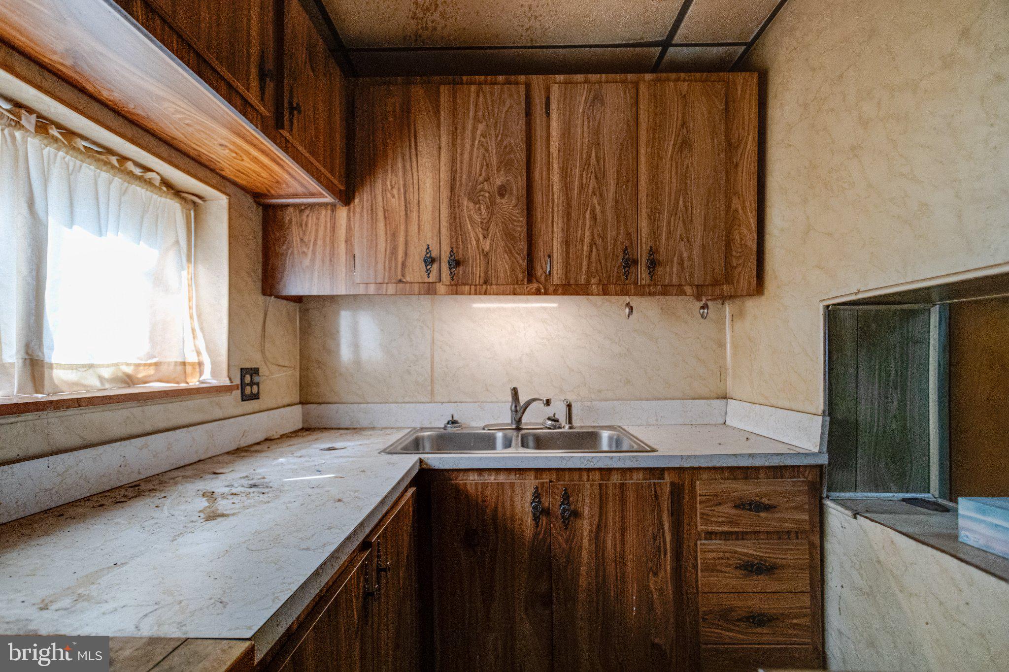 38 South Curley Street Baltimore, MD 21224 - Photo 18 of 38 a kitchen with granite countertop cabinets sink and window