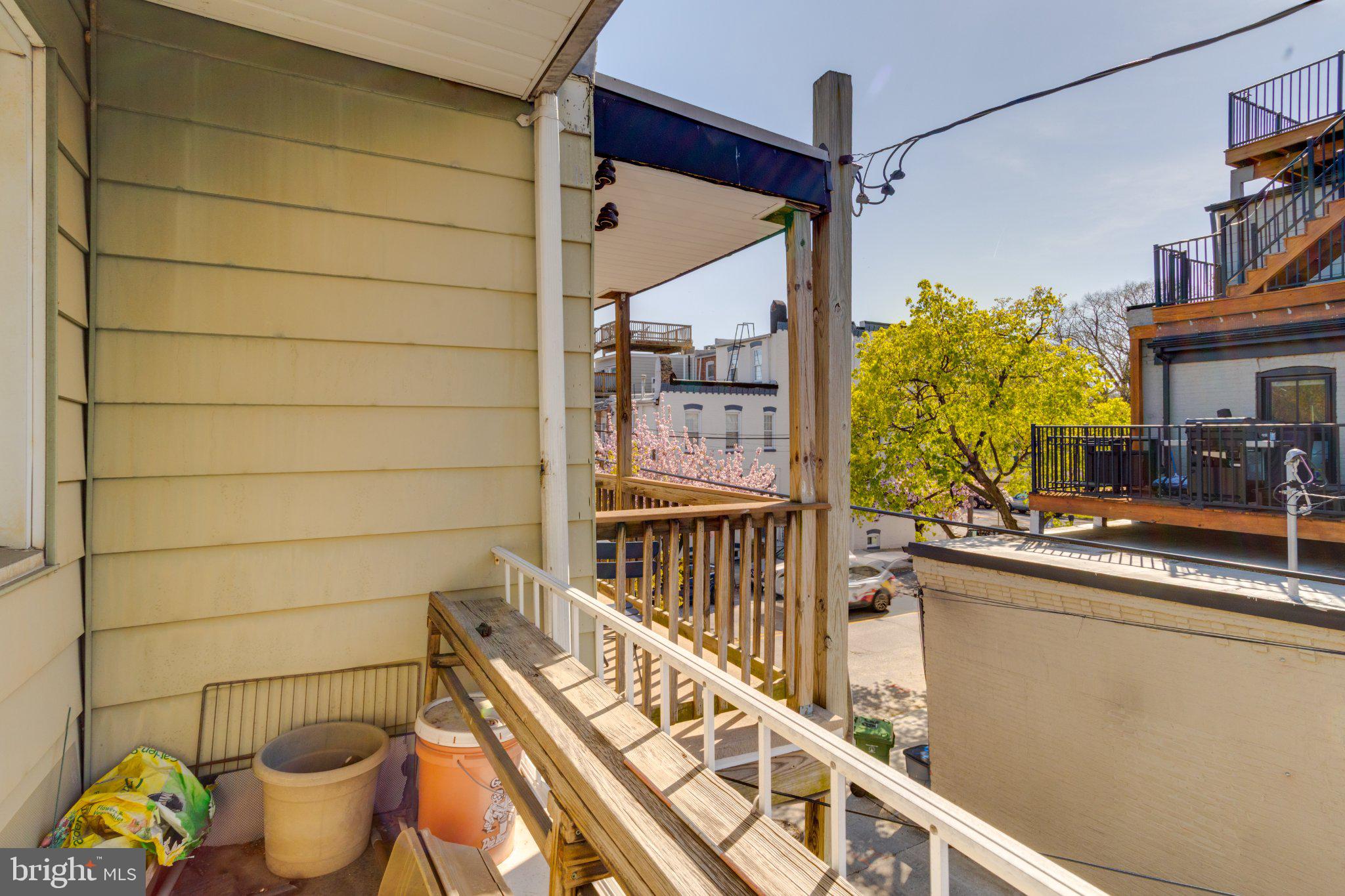 38 South Curley Street Baltimore, MD 21224 - Photo 34 of 38 a view of a balcony with chair and potted plants
