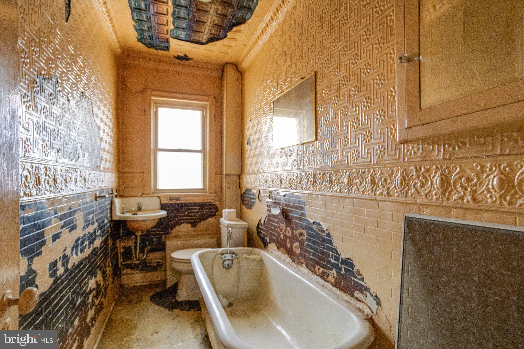 38 South Curley Street Baltimore, MD 21224 - Photo 35 of 38 a bathroom with a tub sink and mirror