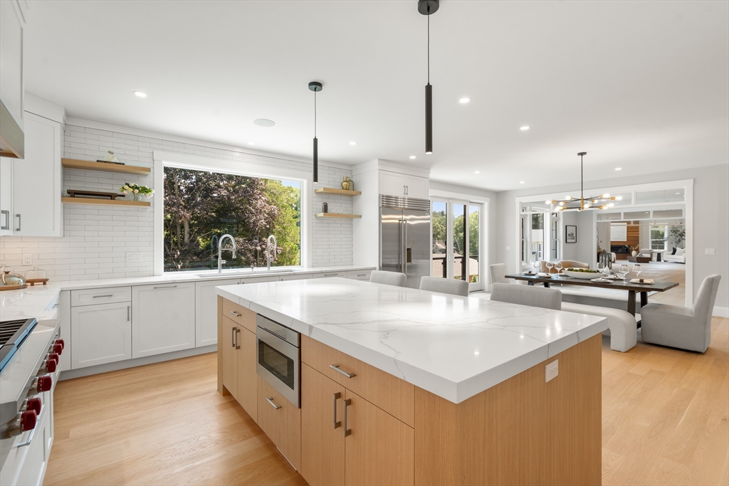 53 Crestview Road Belmont, MA 02478 - Photo 13 of 42 a large kitchen with kitchen island a large counter space appliances and a living room view