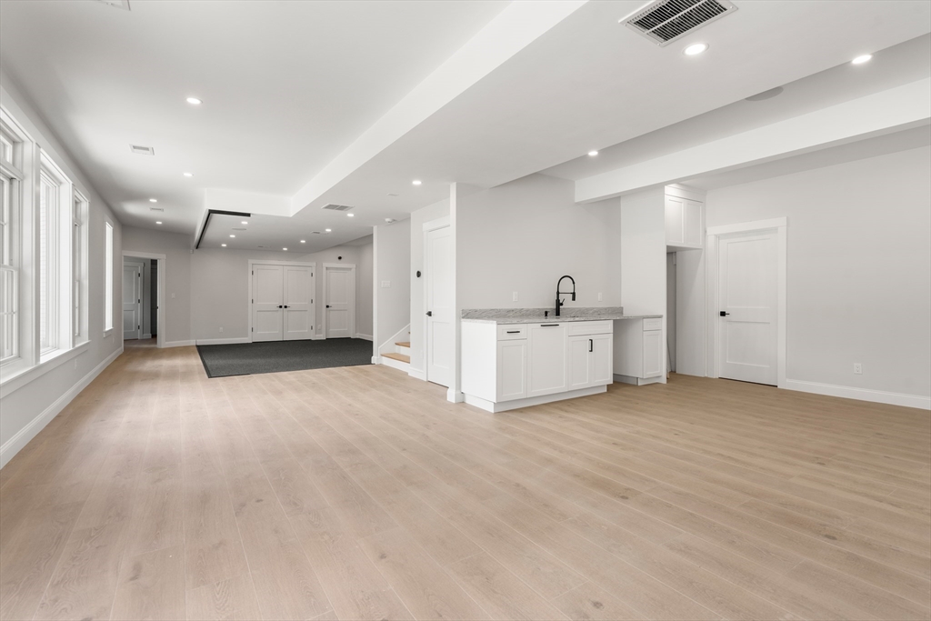 53 Crestview Road Belmont, MA 02478 - Photo 41 of 42 a view of a big room with wooden cabinet and windows