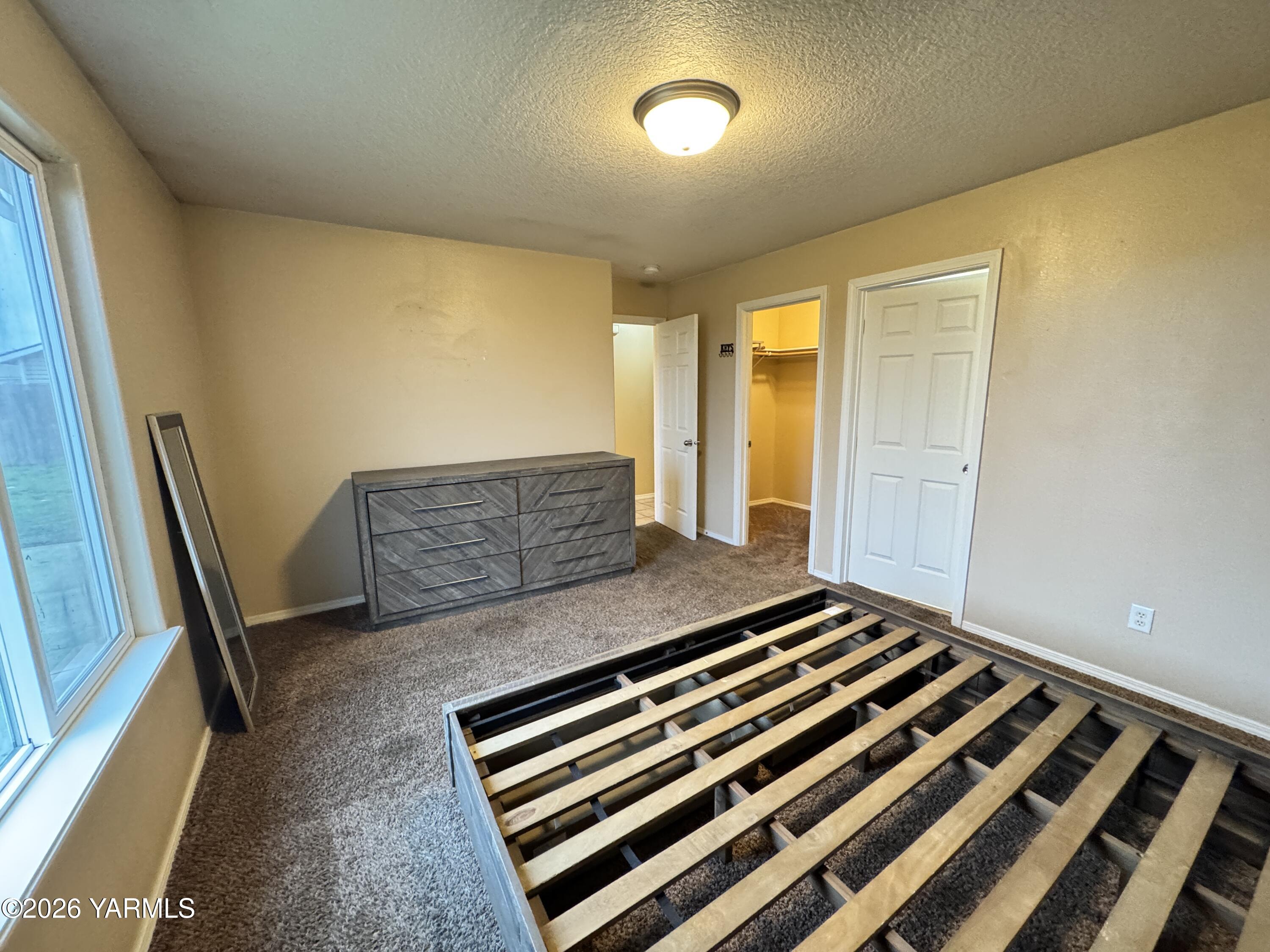 815 Jessica Court Grandview, WA 98930 - Photo 7 of 27 a bedroom with a bed and wooden floor