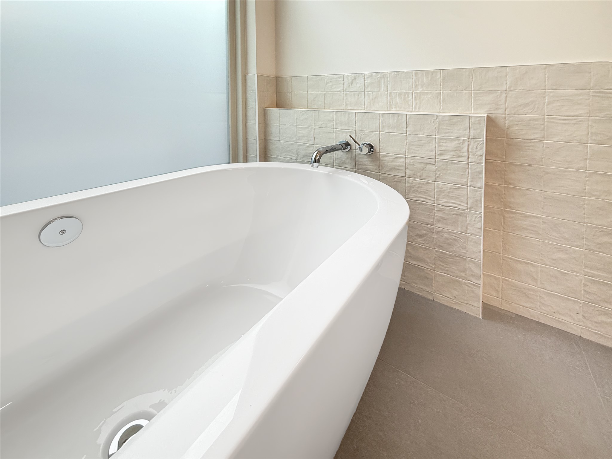 127 Frederick Street Austin, TX 78704 - Photo 18 of 34 Freestanding white soaking tub featuring a wall-mounted chrome faucet