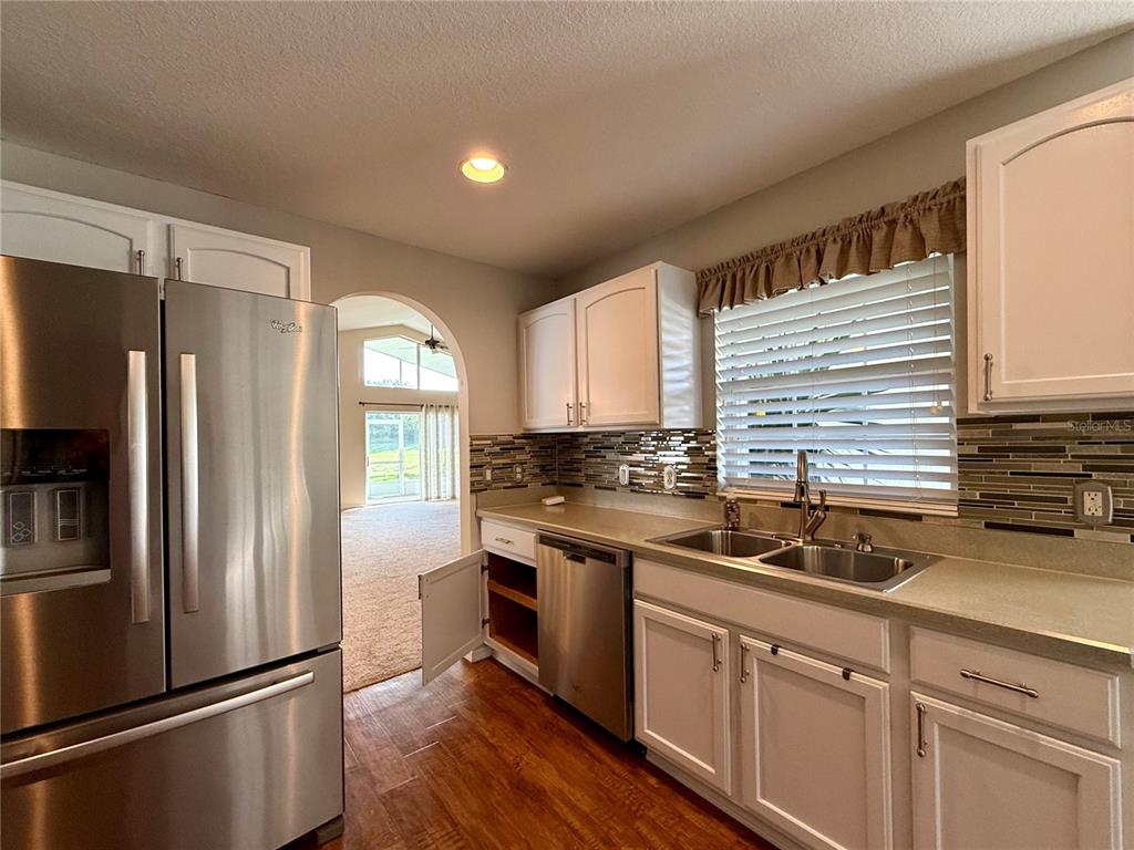 15235 Southwest 14th Avenue Road Ocala, FL 34473 - Photo 13 of 52 a kitchen with stainless steel appliances a refrigerator sink and cabinets