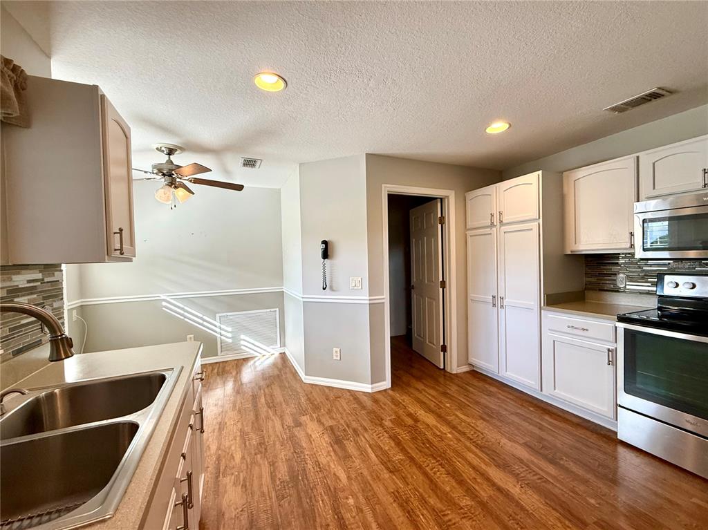 15235 Southwest 14th Avenue Road Ocala, FL 34473 - Photo 16 of 52 a kitchen with granite countertop a sink and a refrigerator