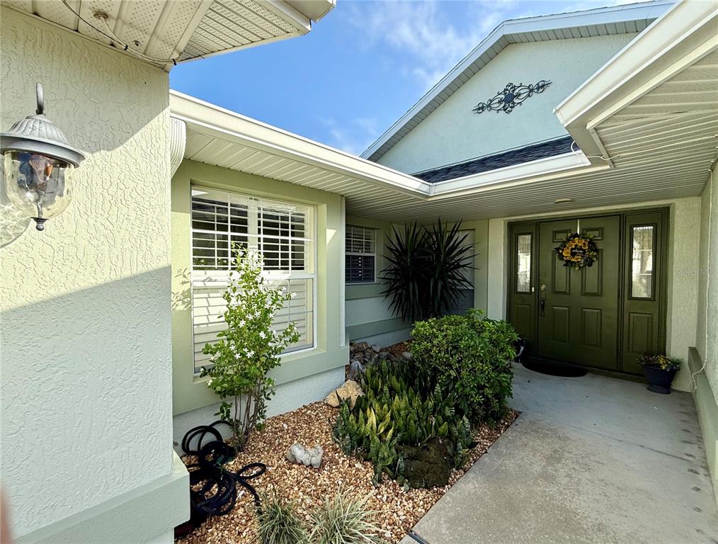 15235 Southwest 14th Avenue Road Ocala, FL 34473 - Photo 5 of 52 a view of yellow house with potted plants