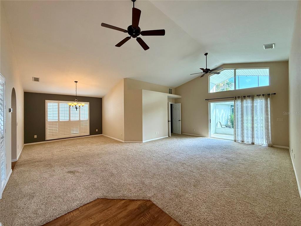 15235 Southwest 14th Avenue Road Ocala, FL 34473 - Photo 7 of 52 a view of an empty room with a window and a ceiling fan