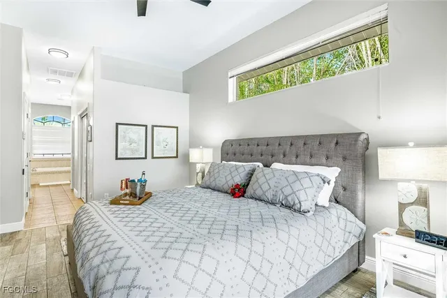 a bedroom with a bed and wooden floor