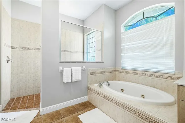 a bathroom with a bathtub and a shower