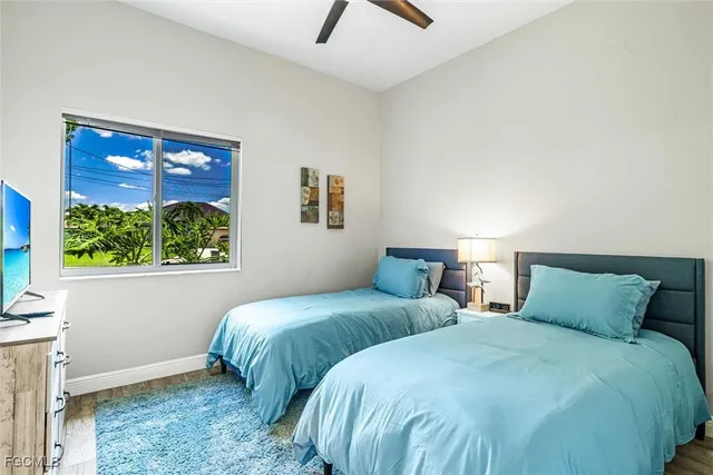 a bedroom with two beds and a window