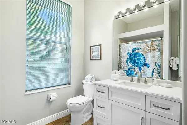 a bathroom with a sink a mirror a toilet and a shower