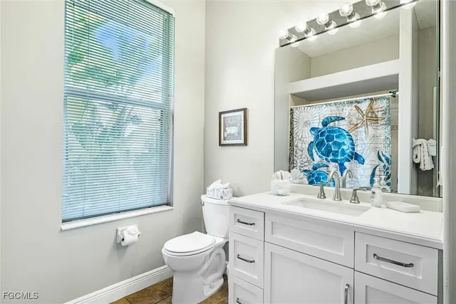 a bathroom with a sink a mirror a toilet and a shower