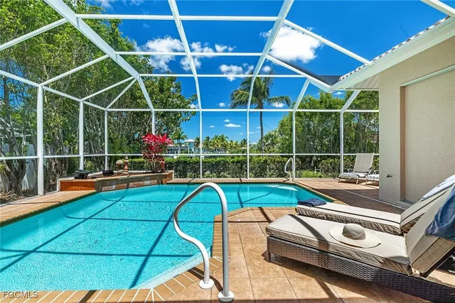 a view of a tennis room with a balcony and large windows