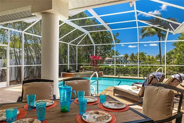 a view of a chairs and tables in the back yard of the house