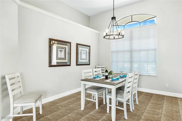 a dining room with furniture a window and a chandelier