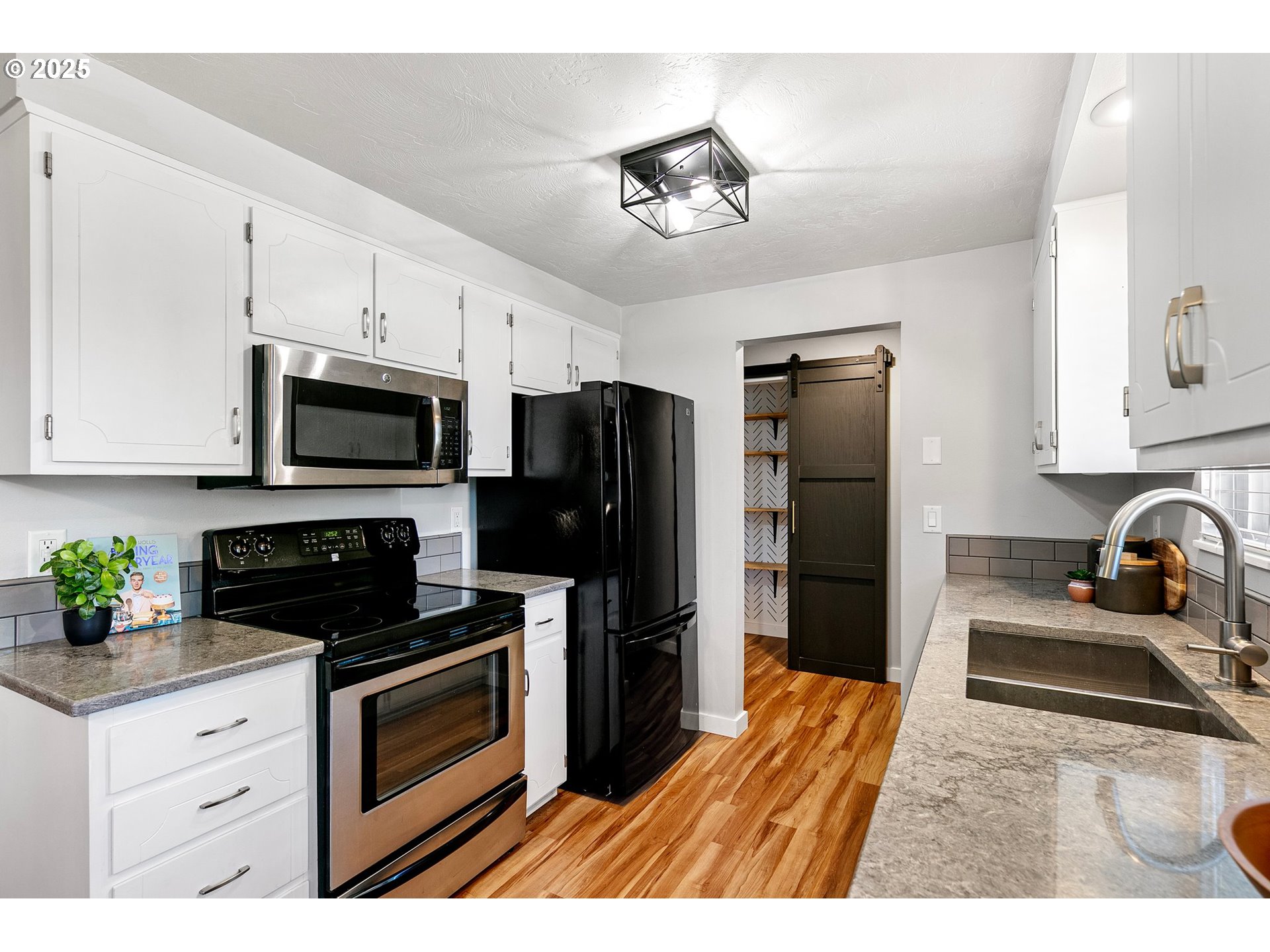 2378 11th Street Springfield, OR 97477 - Photo 11 of 38 a kitchen with granite countertop a refrigerator stove and sink