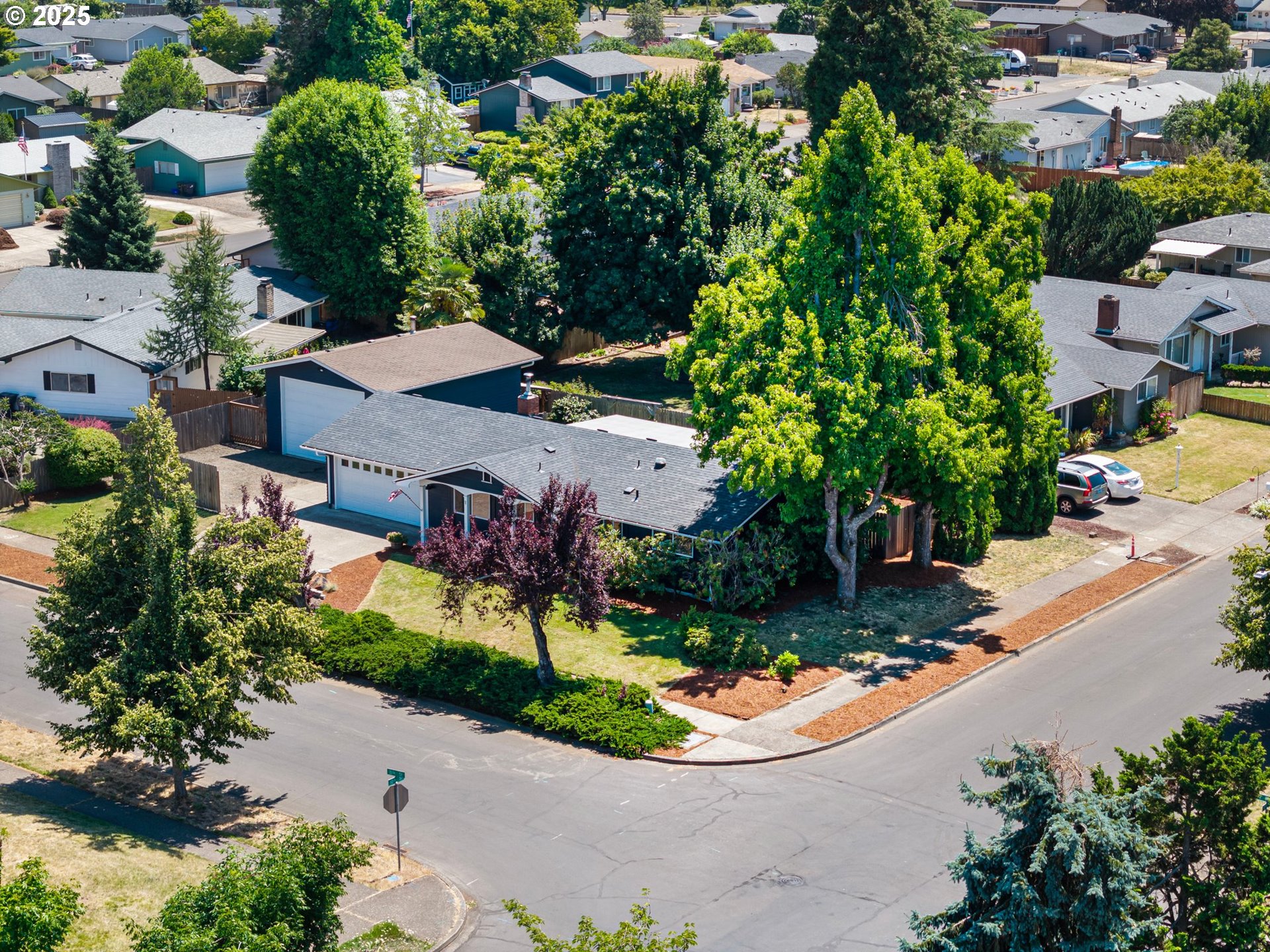2378 11th Street Springfield, OR 97477 - Photo 6 of 38 an aerial view of a house with a garden and trees