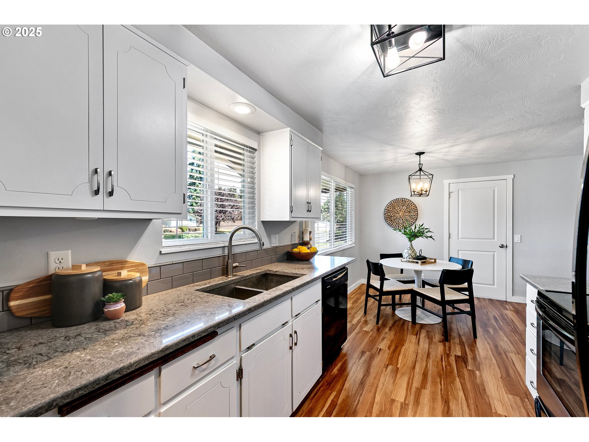 2378 11th Street Springfield, OR 97477 - Photo 10 of 38 a open kitchen with stainless steel appliances granite countertop a stove a sink dishwasher and cabinets with wooden floor