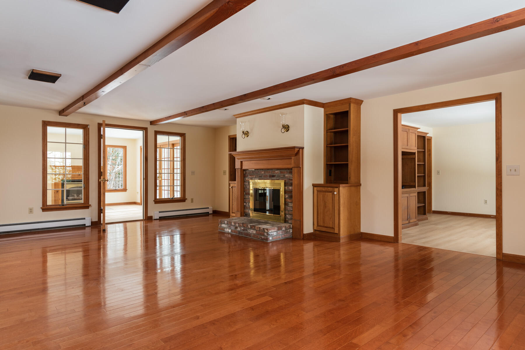 40 Baldwin Road Eastham, MA 02642 - Photo 12 of 37 a view of an entryway with wooden floor fireplace and windows