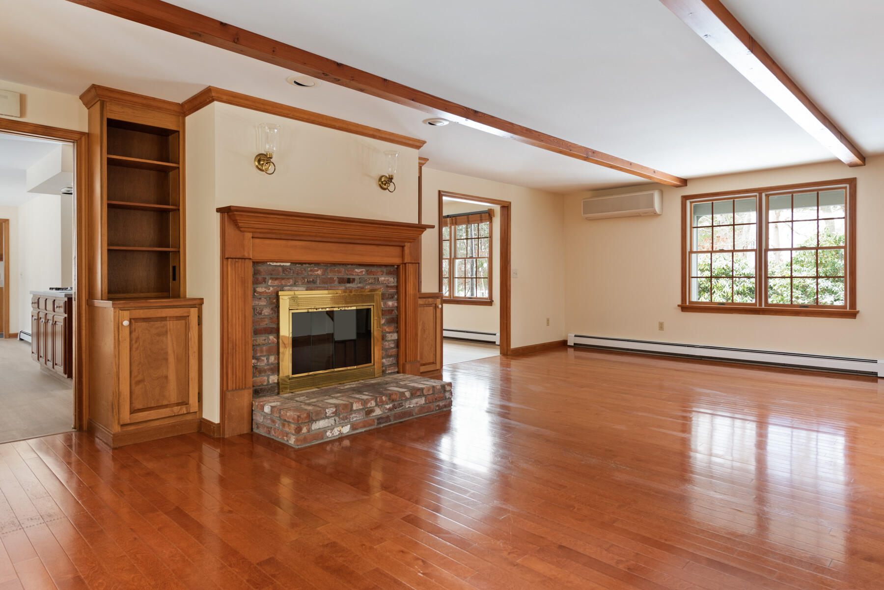 40 Baldwin Road Eastham, MA 02642 - Photo 14 of 37 an empty room with wooden floor fireplace and windows