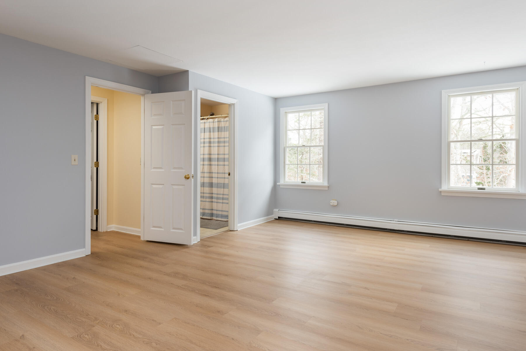 40 Baldwin Road Eastham, MA 02642 - Photo 30 of 37 an empty room with wooden floor and windows