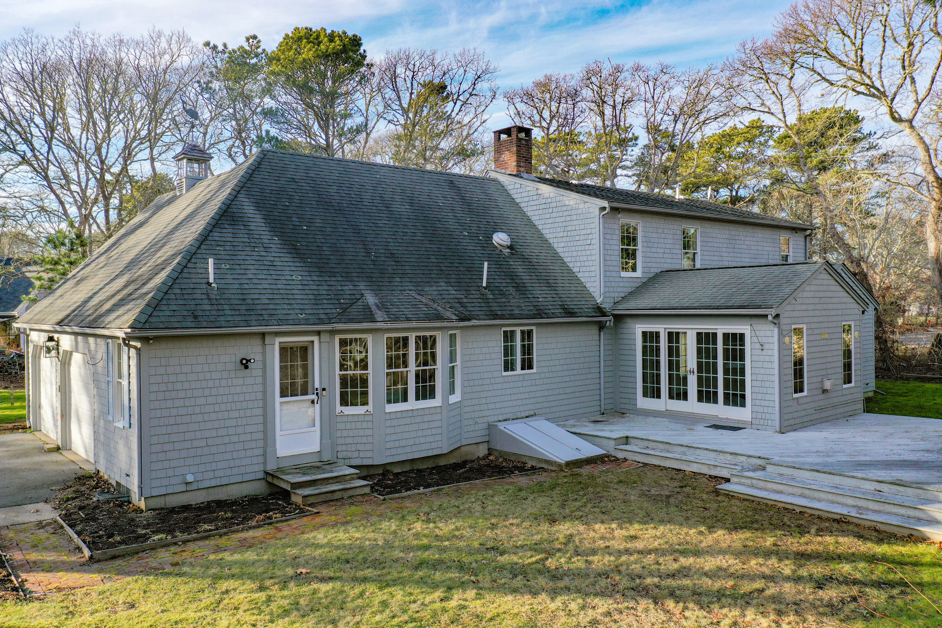40 Baldwin Road Eastham, MA 02642 - Photo 33 of 37 a view of a house with a small yard plants and large tree