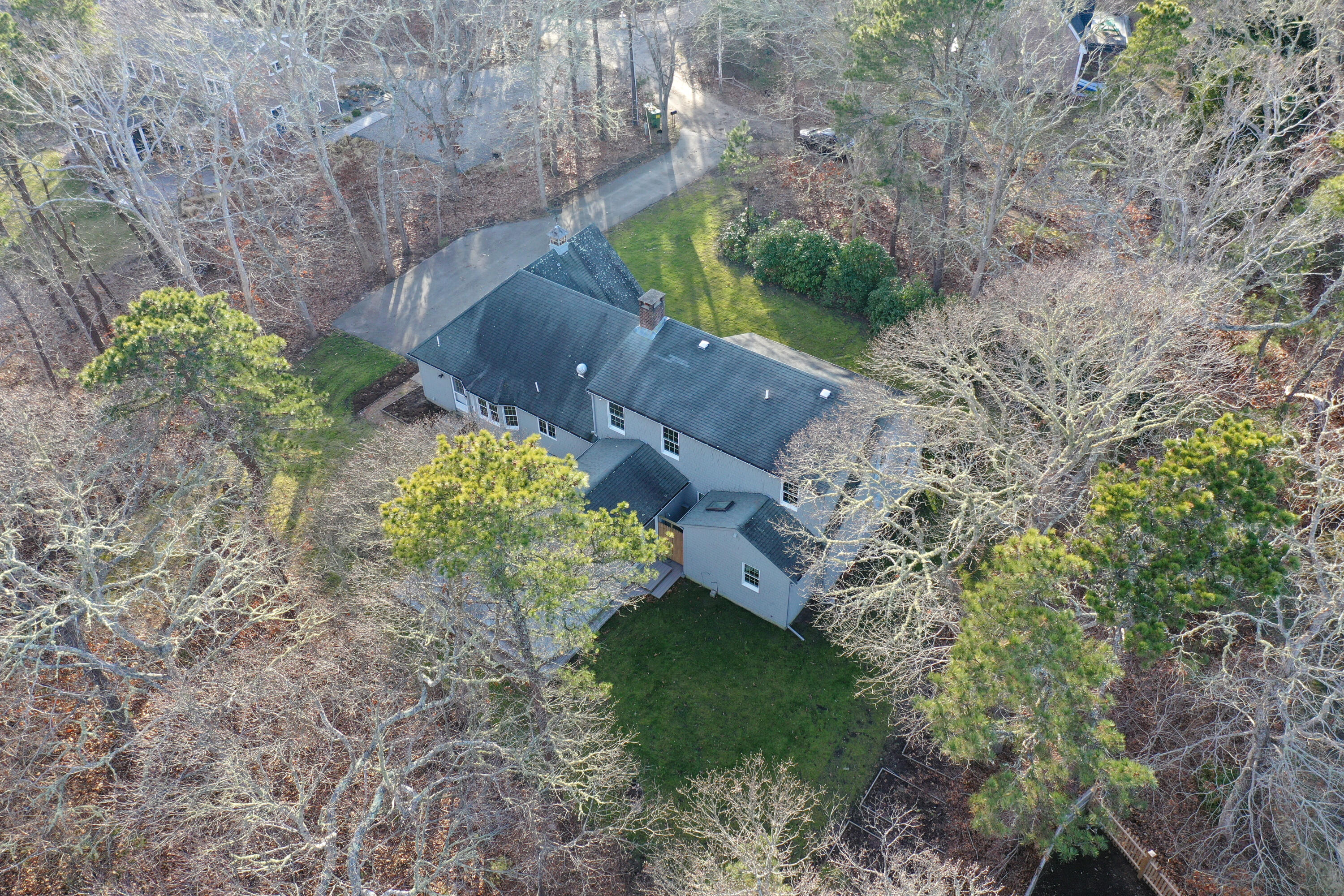 40 Baldwin Road Eastham, MA 02642 - Photo 7 of 37 a picture of trees with side of the house
