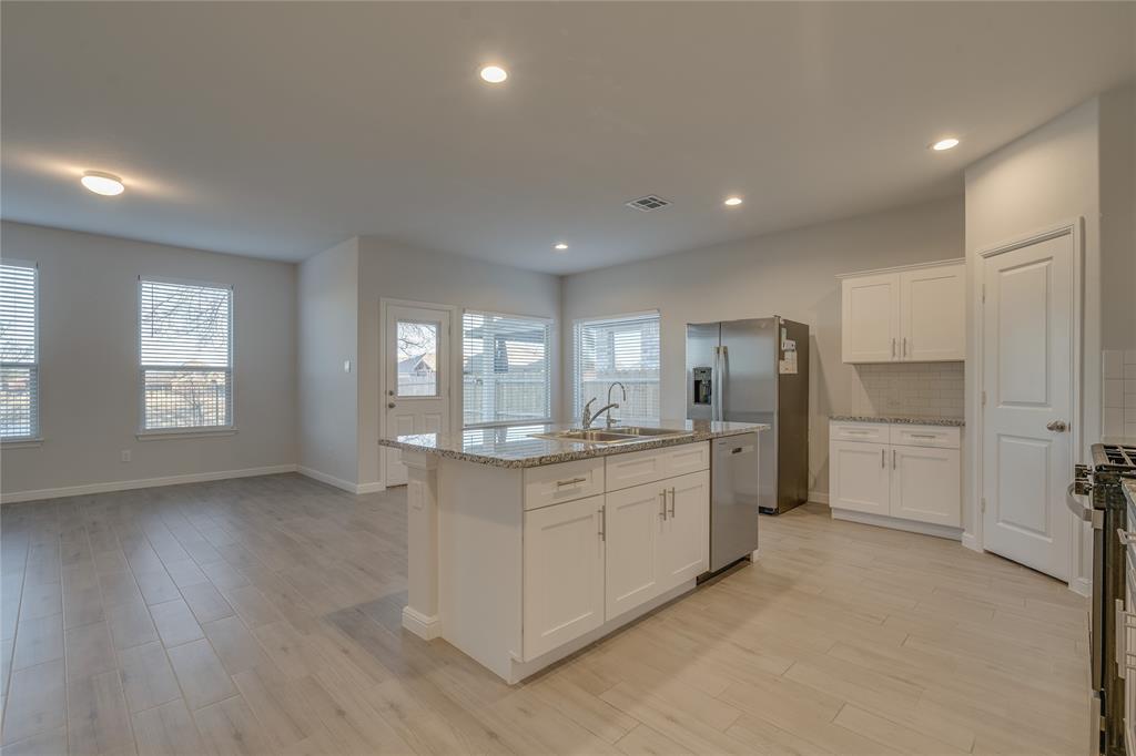 9645 Alderleaf Trail Crowley, TX 76036 - Photo 12 of 33 a large kitchen with stainless steel appliances granite countertop a refrigerator and a stove top oven