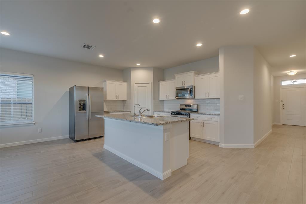 9645 Alderleaf Trail Crowley, TX 76036 - Photo 13 of 33 a kitchen with refrigerator and microwave