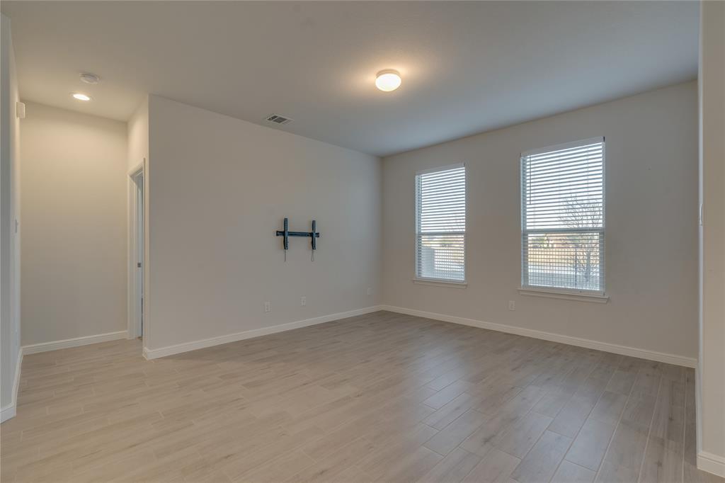 9645 Alderleaf Trail Crowley, TX 76036 - Photo 18 of 33 wooden floor in an empty room with a window