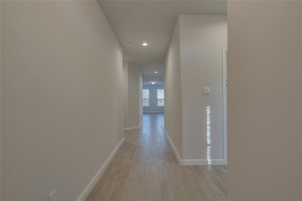 9645 Alderleaf Trail Crowley, TX 76036 - Photo 6 of 33 a view of a hallway with wooden floor