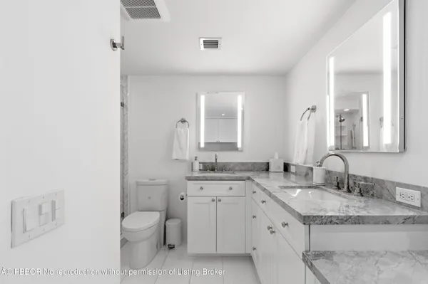 a kitchen with granite countertop white cabinets sink and stainless steel appliances