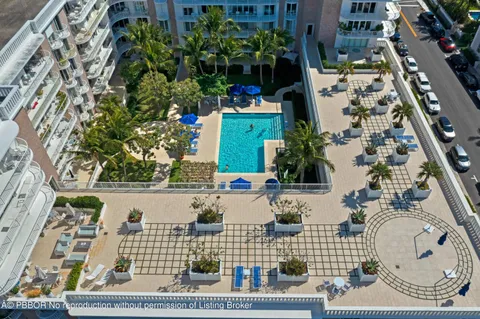a view of a swimming pool with a house in the background