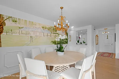 a dining room with furniture and a chandelier