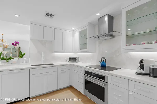 a kitchen with a sink stove top oven and cabinets