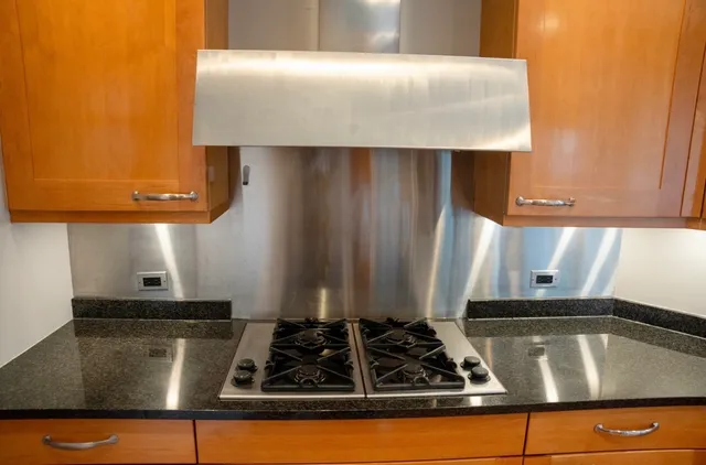 a close view of a sink a stove and a microwave oven in a kitchen